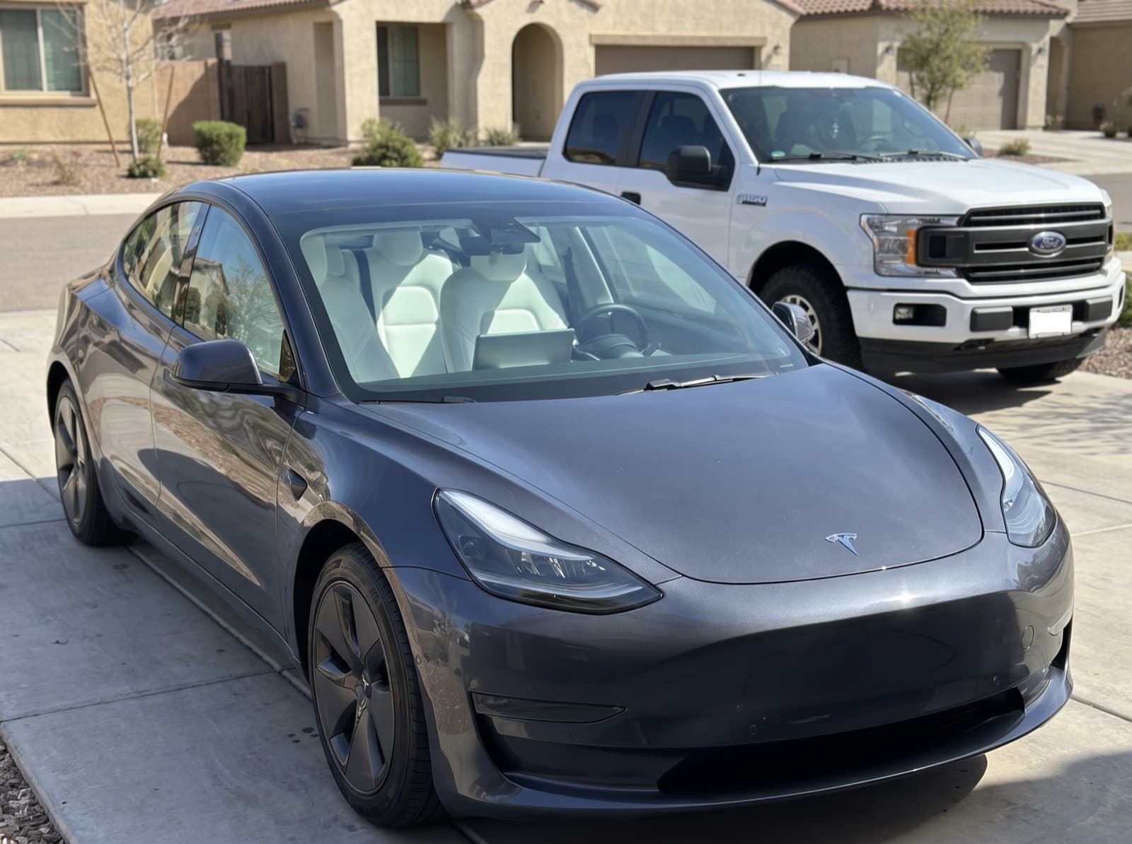 A grey sedan in a driveway in Gilbert, AZ, after a Bang AutoGlass mobile glass job