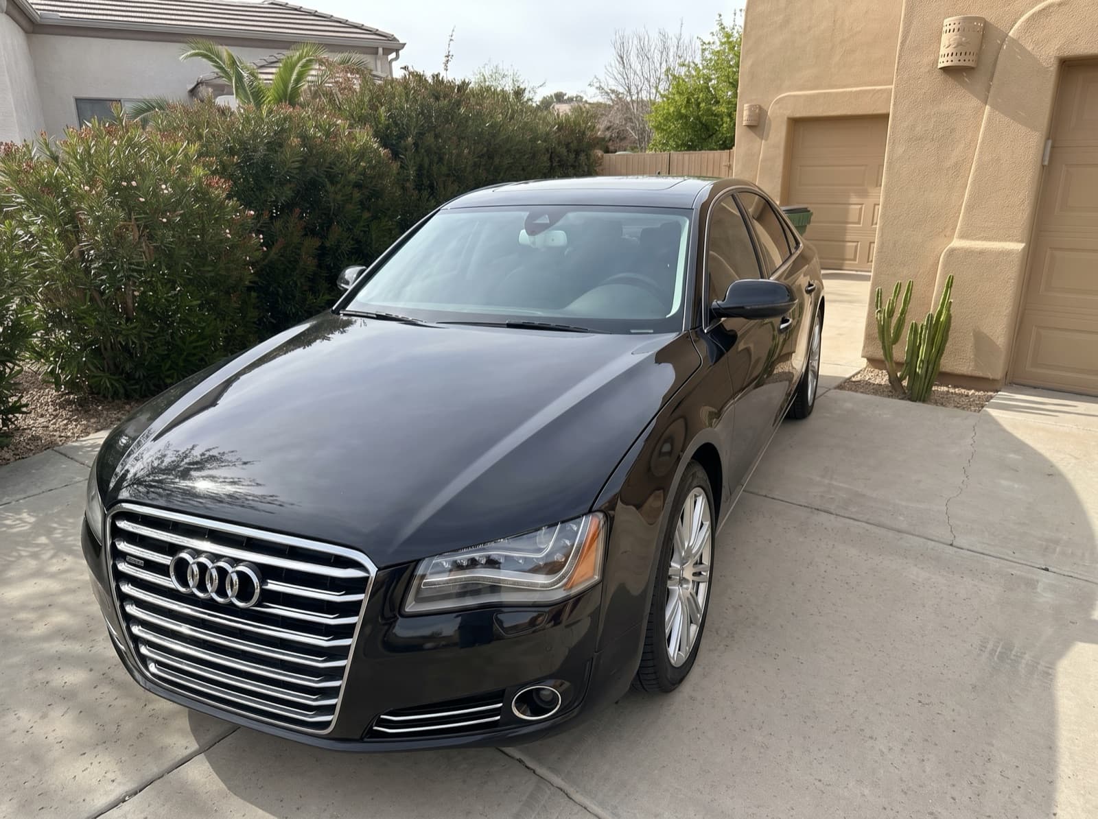 A black sedan in a driveway in Litchfield Park, AZ, after a Bang AutoGlass mobile glass job