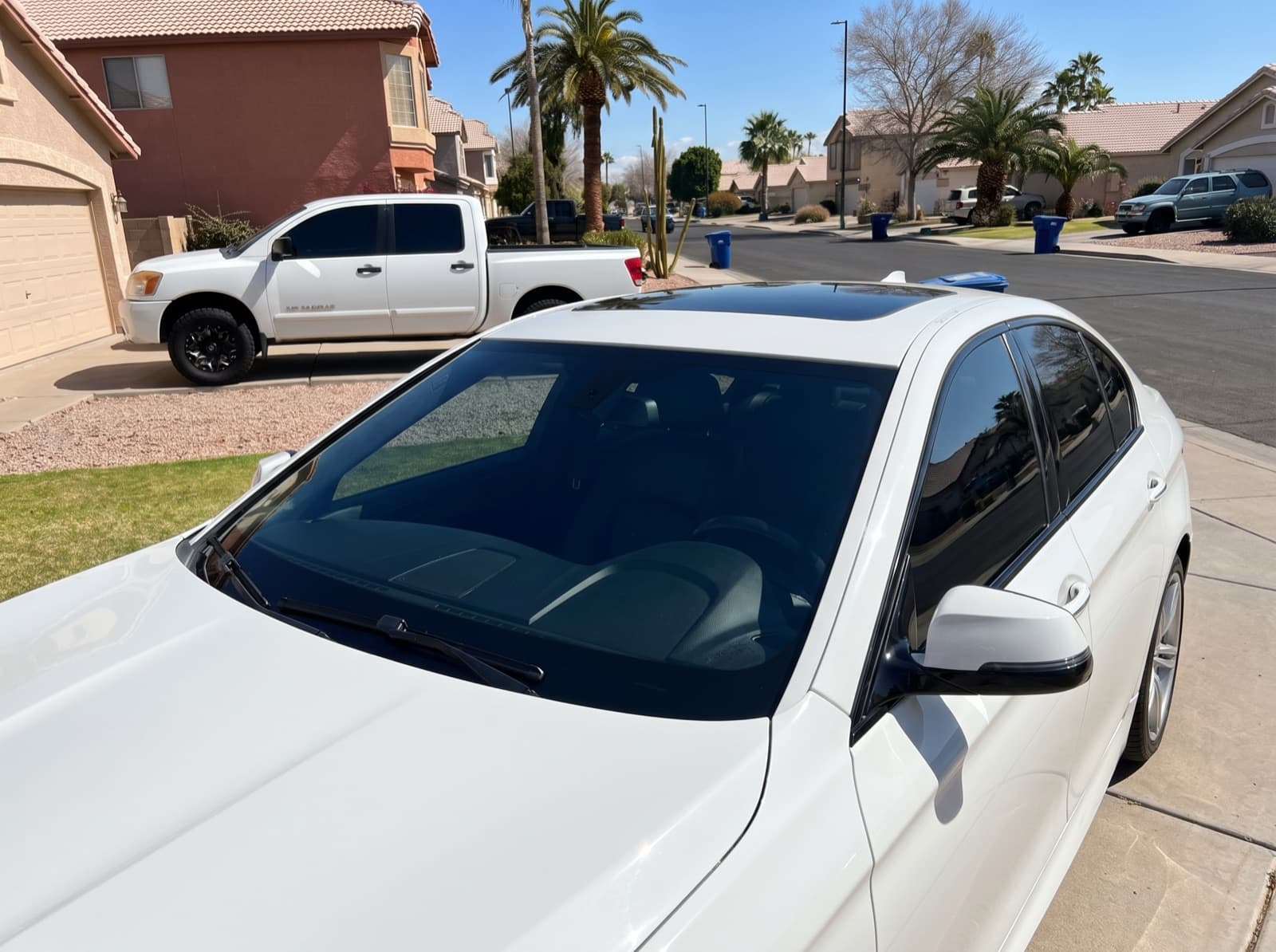 A white sedan on a residential street in Mesa, AZ, after a Bang AutoGlass mobile glass job